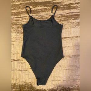 Topshop black stretch bodysuit with silver ring strap embellishments.